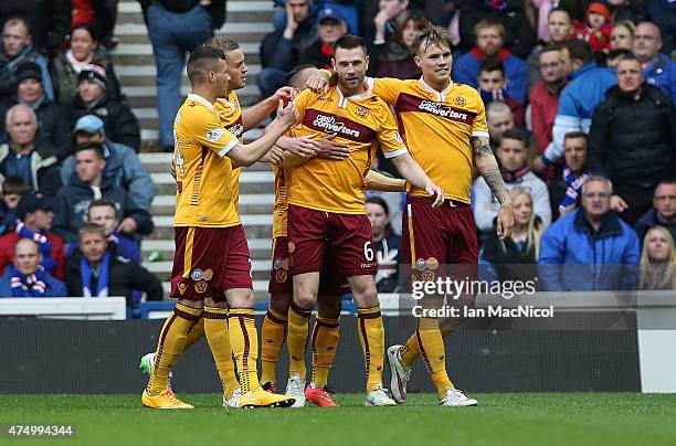 Stephen McManus of Motherwell is congratulated on his goal during the Scottish Premiership play off final, first leg match between Rangers and...