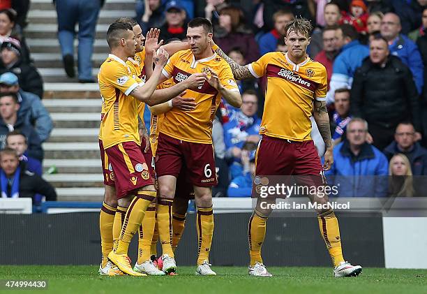 Stephen McManus of Motherwell is congratulated on his goal during the Scottish Premiership play off final, first leg match between Rangers and...