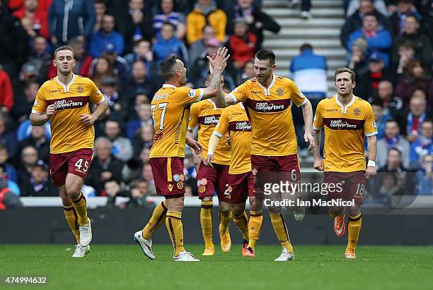 Stephen McManus of Motherwell is congratulated on his goal during the Scottish Premiership play off final, first leg match between Rangers and...