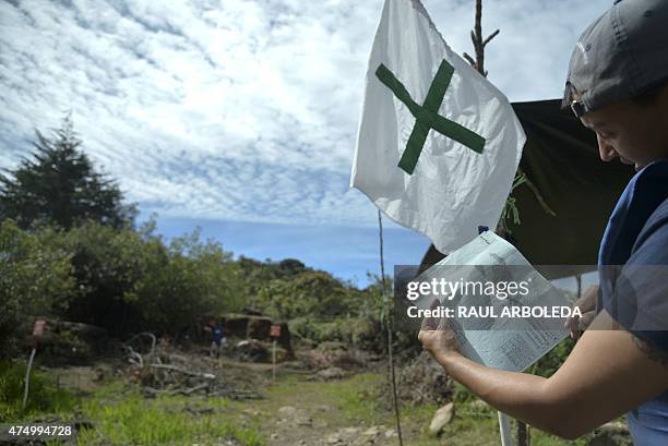 Colombian minesweeper Martha Quintero checks on a chart the area to clear in a minefield laid by guerrillas in La Virgen, Carmen de Viboral...