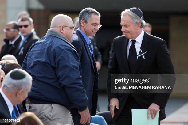 Former British prime minister Tony Blair greets the sons of Ariel Sharon, Omri and Gilad at the start of a state memorial ceremony for former Israeli...