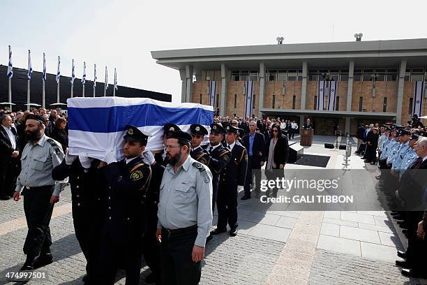 Gilad Sharon, son of former Israeli prime minister Ariel Sharon, walks behind his father's coffin as an honor guard carries it during the state...