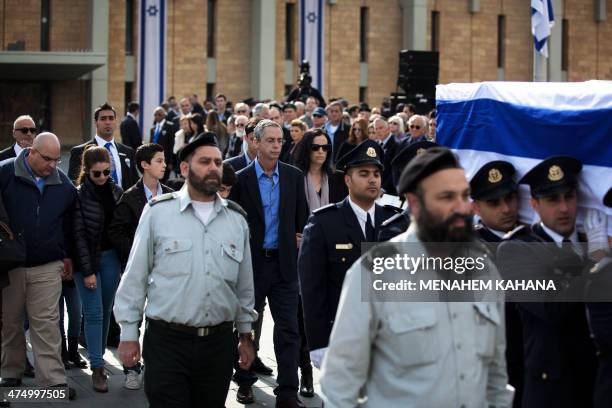 Former Israeli prime minister Ariel Sharon's sons Omri and Gilad and grandchildren walk behind his national flag-draped coffin during a state...