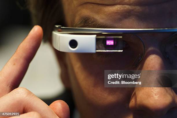 An employee demonstrates how a pair of Google Glass connected glasses are capable of reading barcodes on day three of the Mobile World Congress in...