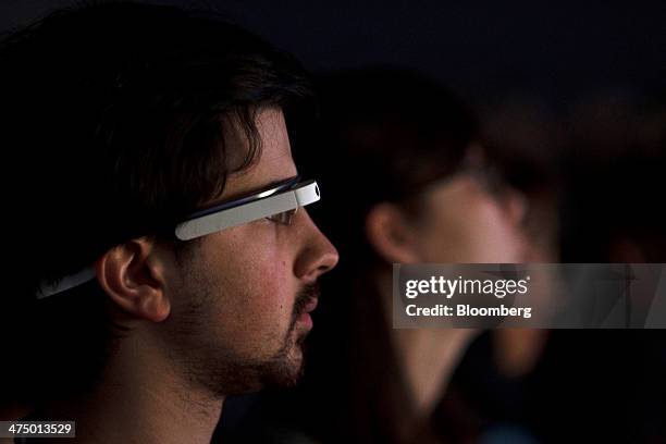 An attendee wears a pair of Google Glass connected glasses while listening to a speaker on day three of the Mobile World Congress in Barcelona,...