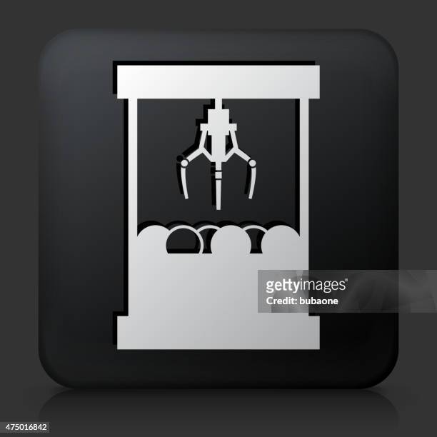 black square button with toy grabber icon - claw machine stock illustrations