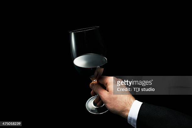 man holding a glass of red wine - wine close up stock pictures, royalty-free photos & images