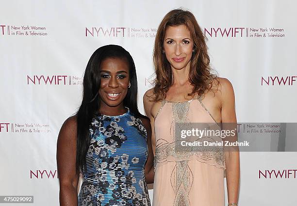 Uzo Aduba and Alysia Reiner attend the 2015 New York Women In Film & Television Designing Women Awards Gala at Scholastic Auditorium on May 28, 2015...