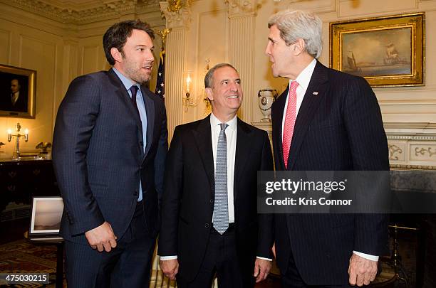 Ben Affleck, former U.S. Sen. Russ Feingold and U.S. Secretary of State John Kerry speak during a photo op at The State Department on February 26,...