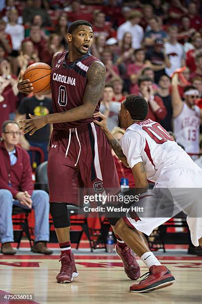 Sindarius Thornwell of the South Carolina Gamecocks looks to make a play while being defended by Rashad Madden of the Arkansas Razorbacks at Bud...