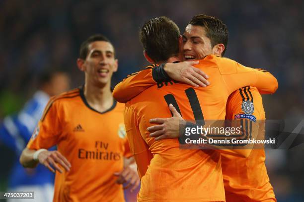 Gareth Bale of Real Madrid celebrates with team mate Cristiano Ronaldo after scoring his team's second goal during the UEFA Champions League Round of...
