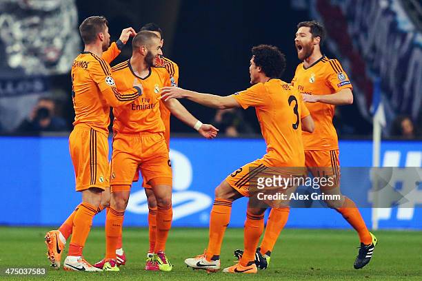Karim Benzema 82L) of Madrid celebrates his team's first goal with team mates during the UEFA Champions League Round of 16 first leg match between FC...
