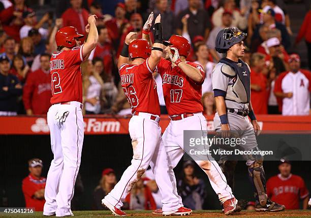 Chris Iannetta celebrates with teammates Kole Calhoun and Kirk Nieuwenhuis after hitting a grand slam in the seventh inning as catcher James McCann...