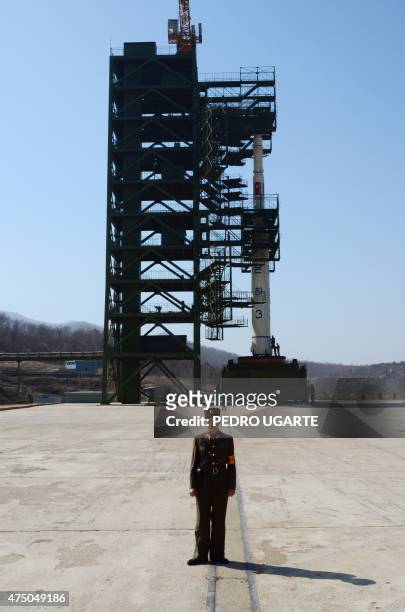 North Korean soldier stands guard in front of the Unha-3 rocket at the Sohae Satellite Launch Station in Tongchang-Ri on April 8, 2012. North Korea...