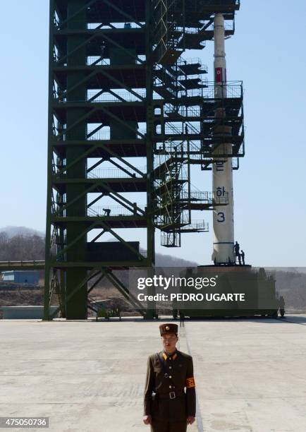 North Korean guard stands in front of the Unha-3 rocket at the Sohae Satellite Launch Station in Tongchang-Ri on April 8, 2012. North Korea has...
