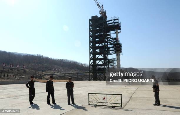 North Korean soldiers stand guard in front of the Unha-3 rocket at the Sohae Satellite Launch Station in Tongchang-Ri on April 8, 2012. North Korea...