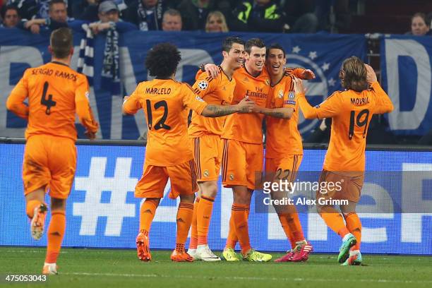 Gareth Bale of Madrid celebrates his team's second goal with team mates during the UEFA Champions League Round of 16 first leg match between FC...