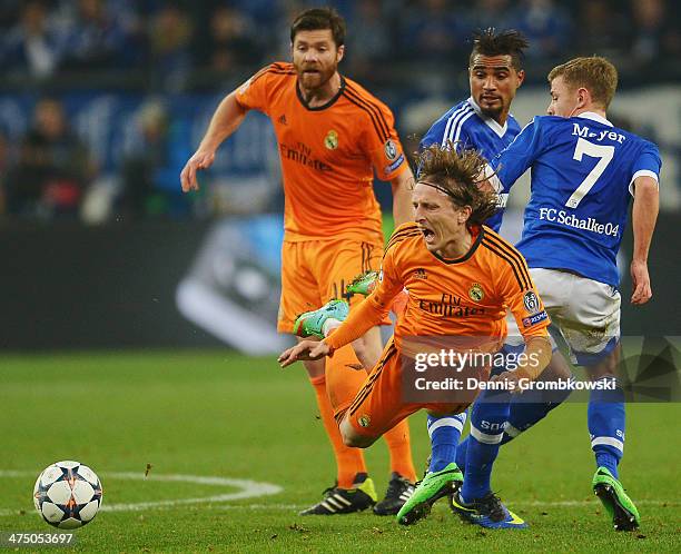 Luka Modric of Real Madrid is challenged by Max Meyer of FC Schalke 04 during the UEFA Champions League Round of 16 first leg match between Schalke...