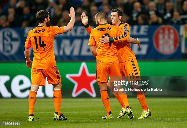 Karim Benzema Xabi Alonso and Gareth Bale of Real Madrid celebrate after scoring during the UEFA Champions League Round of 16 first leg match between...