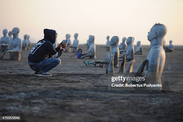 Survivors statues are displayed at mudflow areas to signify the lives of victims who suffered during ninth anniversary of the Lapindo mudflow...