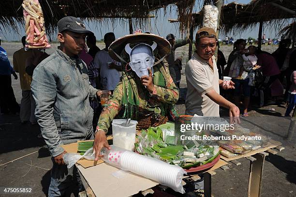 Lapindo mudflow victims sell food for charity during the ninth anniversary of the Lapindo mudflow eruption on May 29, 2015 in Porong, Indonesia....