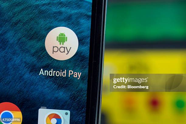 An attendee displays Google Inc. Android Pay icon on a mobile device for a photograph during the Google I/O Annual Developers Conference in San...