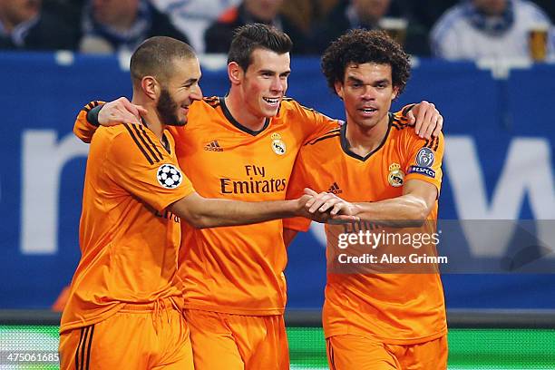 Gareth Bale of Madrid celebrates his team's fifth goal with team mates Karim Benzema and Pepe during the UEFA Champions League Round of 16 first leg...