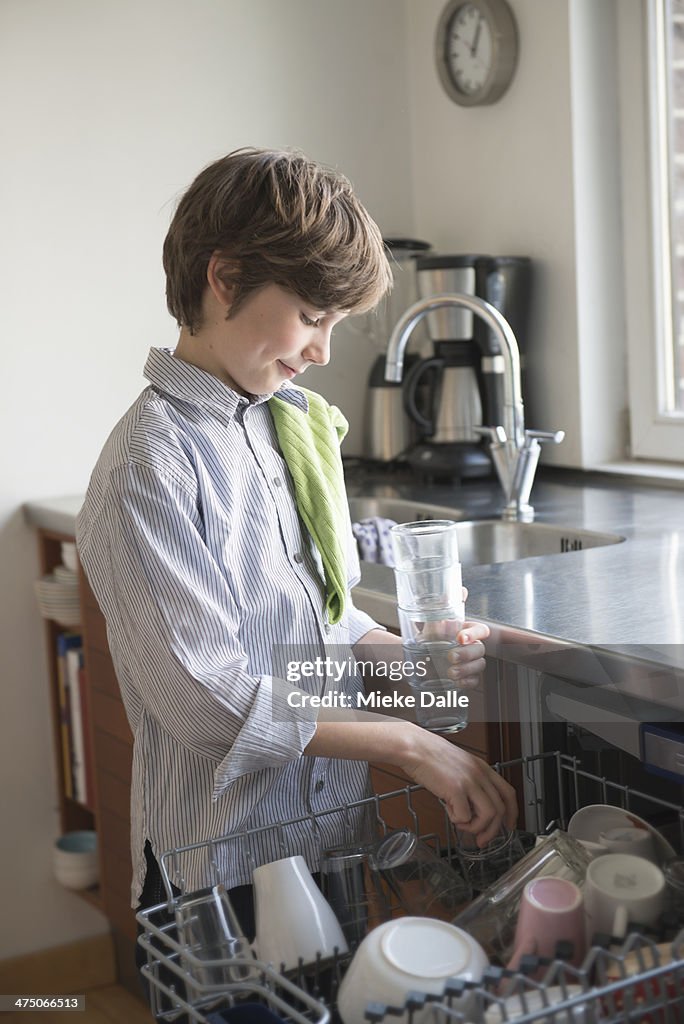 Child emptying the dishwasher