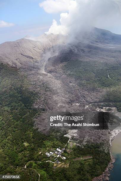 In this aerial image, volcanic ash spews from Mount Shindake, left the scar of pyroclastic flow at Kuchinoerabujima Island on May 29, 2015 in...