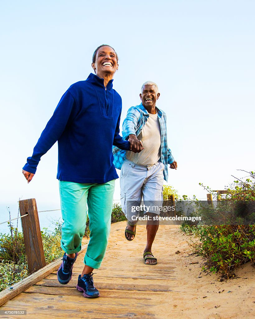 Couple walking on boardwalk.