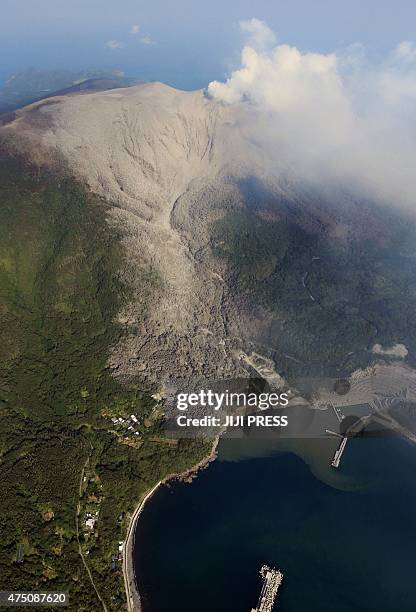 An aerial view taken on May 29, 2015 shows smoke rising from Mount Shindake on Kuchinoerabu island in Kagoshima prefecture of Japan's southern island...