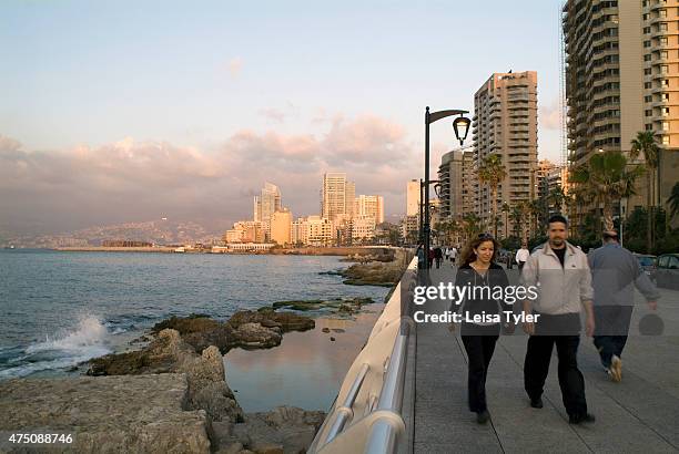 Walkers on Beirut's Corniche, a spacious palm fringed boardwalk that hugs the sides of the Mediterranean. All of Beiruts denizens come to promenade...