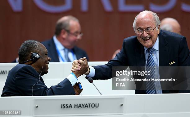 President Joseph S. Blatter shakes hands with FIFA Senior Vice President Issa Hayatou of Cameroon during the 65th FIFA Congress at the Hallenstadion...