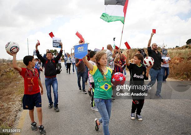 Group of Palestinian children gather to asking FIFA to suspend Israel from world football, in Ramallah, West Bank, on May 29, 2015. They hold...