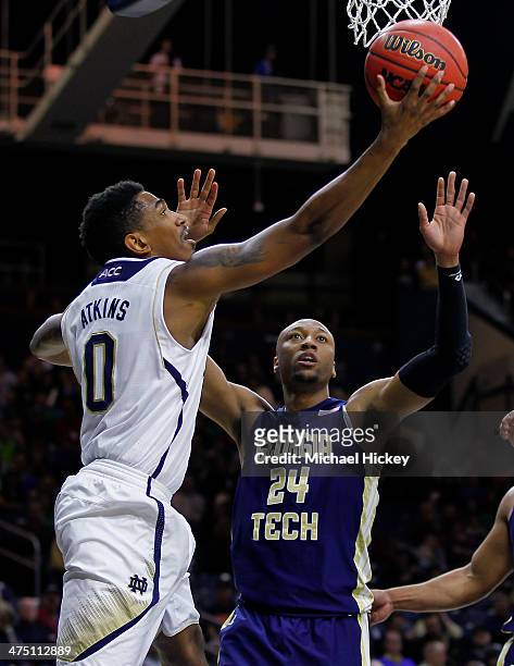 Eric Atkins of the Notre Dame Fighting Irish shoots the ball against Kammeon Holsey of the Georgia Tech Yellow Jackets at Purcel Pavilion on February...