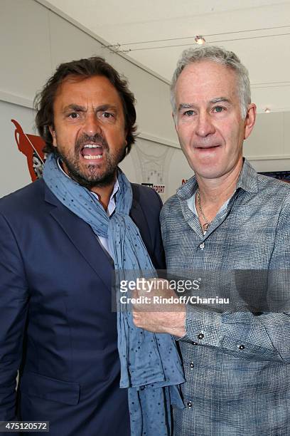 Tennis Players Henri Leconte and John McEnroe attend the 2015 Roland Garros French Tennis Open - Day Six, on May 29, 2015 in Paris, France.
