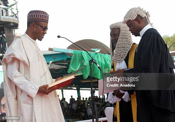 Nigerian President Muhammadu Buhari taking his oath of office before Chief Justice of Nigeria, Justice Mahmud Mohammed during his inauguration in...