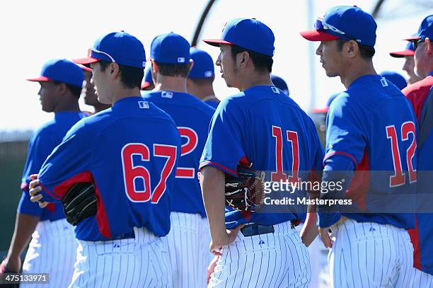Tsuyoshi Wada, Kyuji Fujikawa, and Chang-Yong Lim of Chicago Cubs look on during the Chicago Cubs spring training on February 26, 2014 in Mesa,...