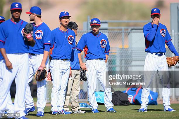 Kyuji Fujikawa and Tsuyoshi Wada look on during the Chicago Cubs spring training on February 26, 2014 in Mesa, Arizona.