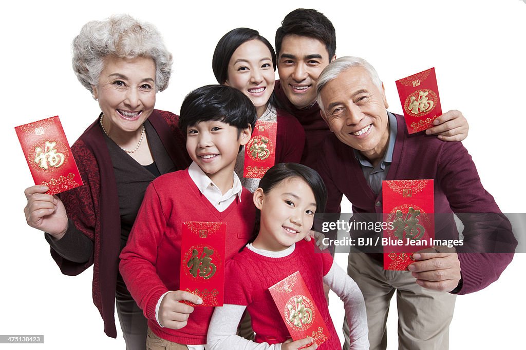 Happy family showing red pockets celebrating Chinese New Year