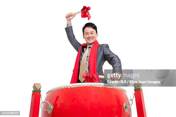 businessman playing traditional chinese red drum - bedug stock pictures, royalty-free photos & images