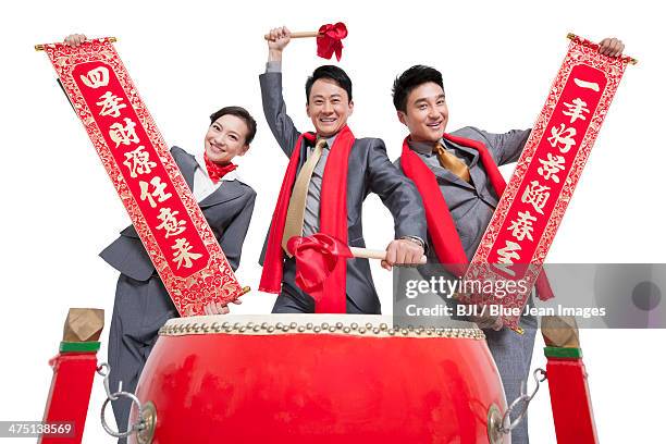 business team playing traditional chinese red drum and showing couplets - bedug stock pictures, royalty-free photos & images