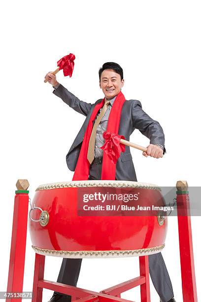 businessman playing traditional chinese red drum - bedug stock pictures, royalty-free photos & images