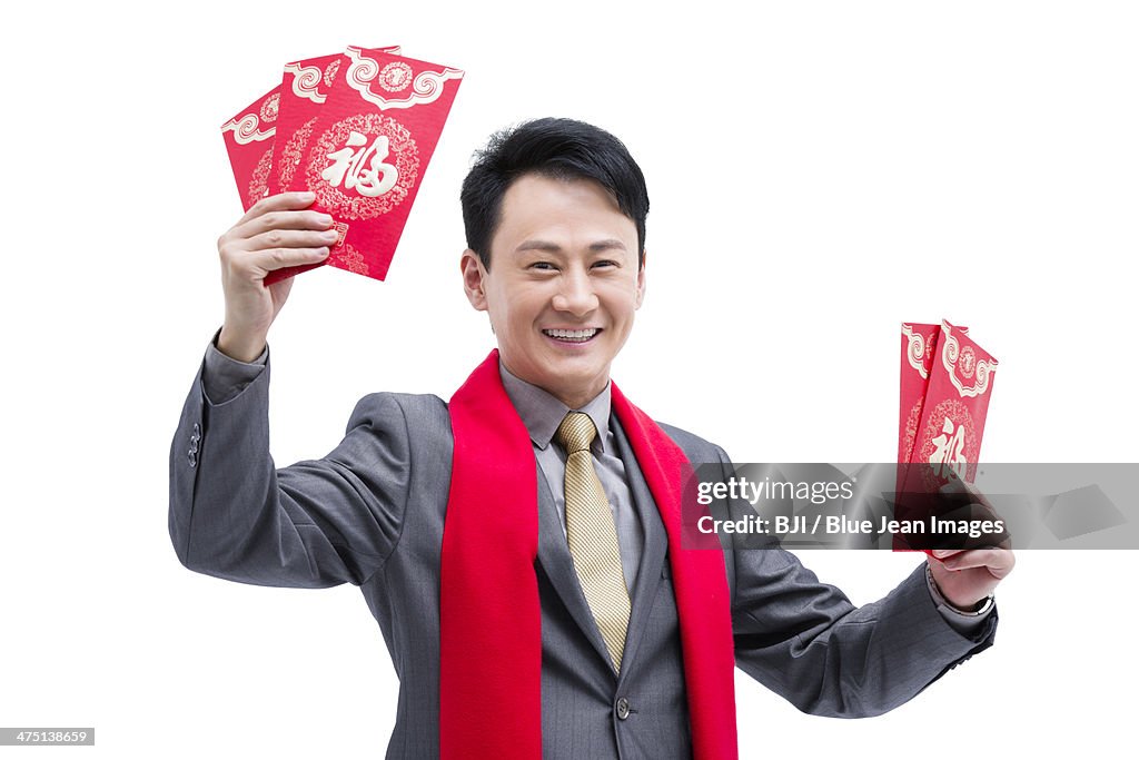 Happy business colleagues gifting traditional red envelopes