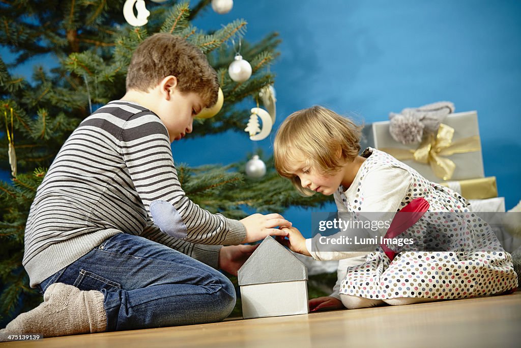 Children unwrapping Christmas presents, Munich, Bavaria, Germany