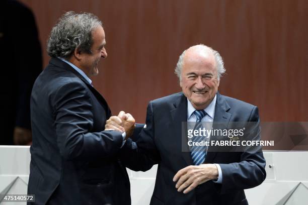 President Sepp Blatter is congratulated by UEFA President Michel Platini after being re-elected during the FIFA Congress in Zurich on May 29, 2015....