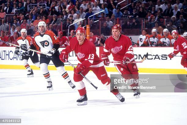 Vyacheslav Kozlov and Greg Johnson of the Detroit Red Wings skate on the ice during an NHL preseason game against the Philadelphia Flyers in...