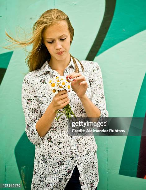 portrait of young woman with bunch of daisies - graffiti hintergrund stock pictures, royalty-free photos & images