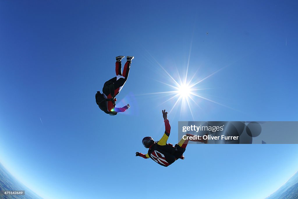 Skydivers upside down above Leutkirch, Bavaria, Germany
