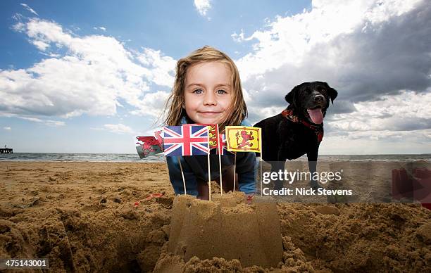 young girl on with sandcastle on beach, walberswick, suffolk, england, uk - walberswick stock pictures, royalty-free photos & images